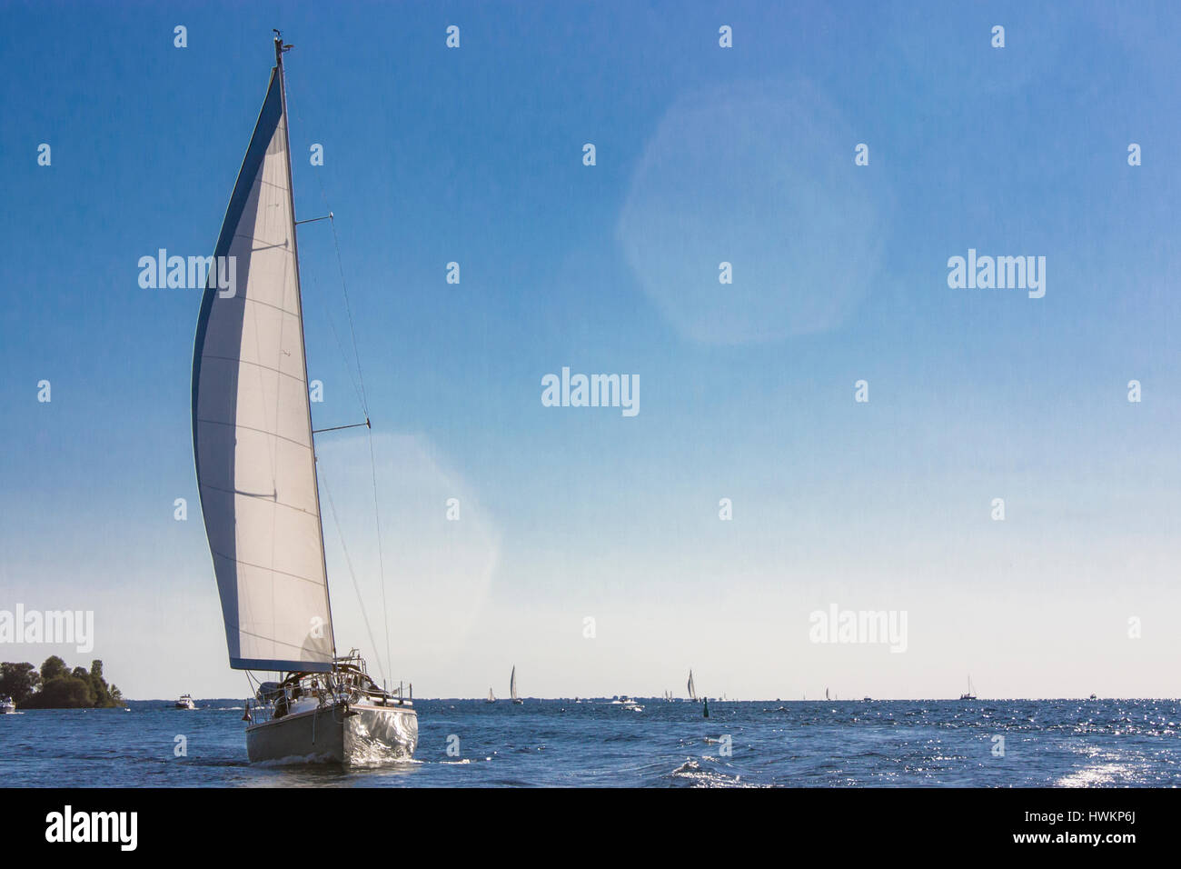 white sail boat on blue sky Stock Photo - Alamy