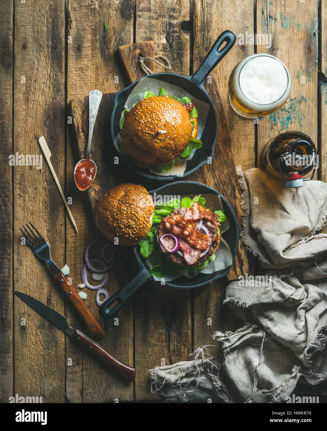 Homemade beef burgers with crispy bacon and fresh vegetables in small