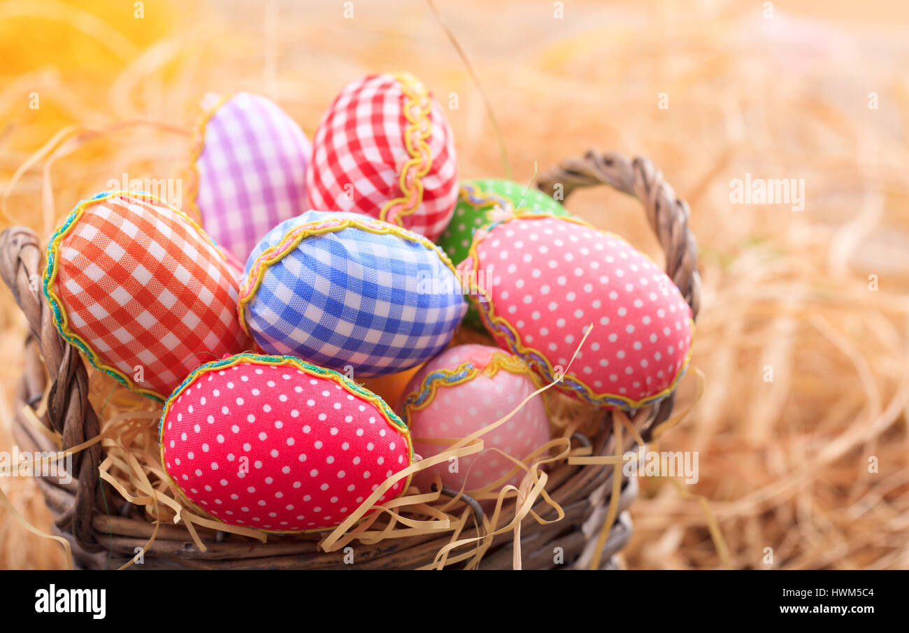 Colorful pastel Easter eggs on straw background Stock Photo - Alamy