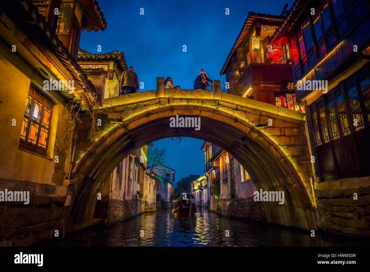 SHANGHAI, CHINA: Beautiful evening light creates magic mood inside Zhouzhuang water town, ancient city district with channels and old buildings, charming popular tourist area Stock Photo