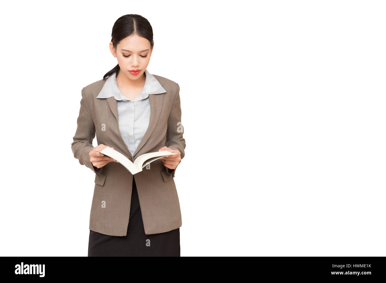 Business woman reading a book, isolated on white background. Stock Photo