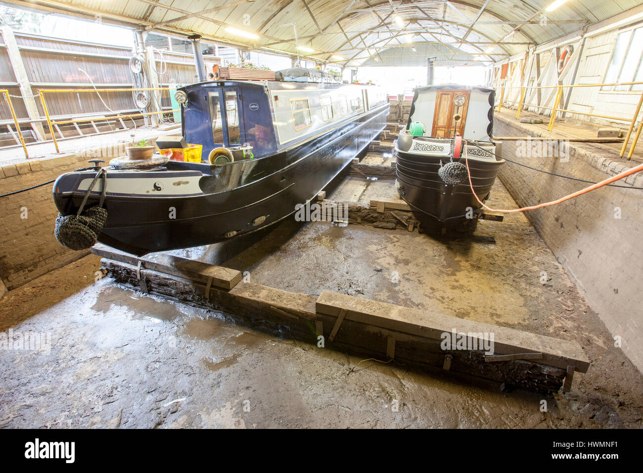 pair of narrowboats in dry dock for blacking Stock Photo
