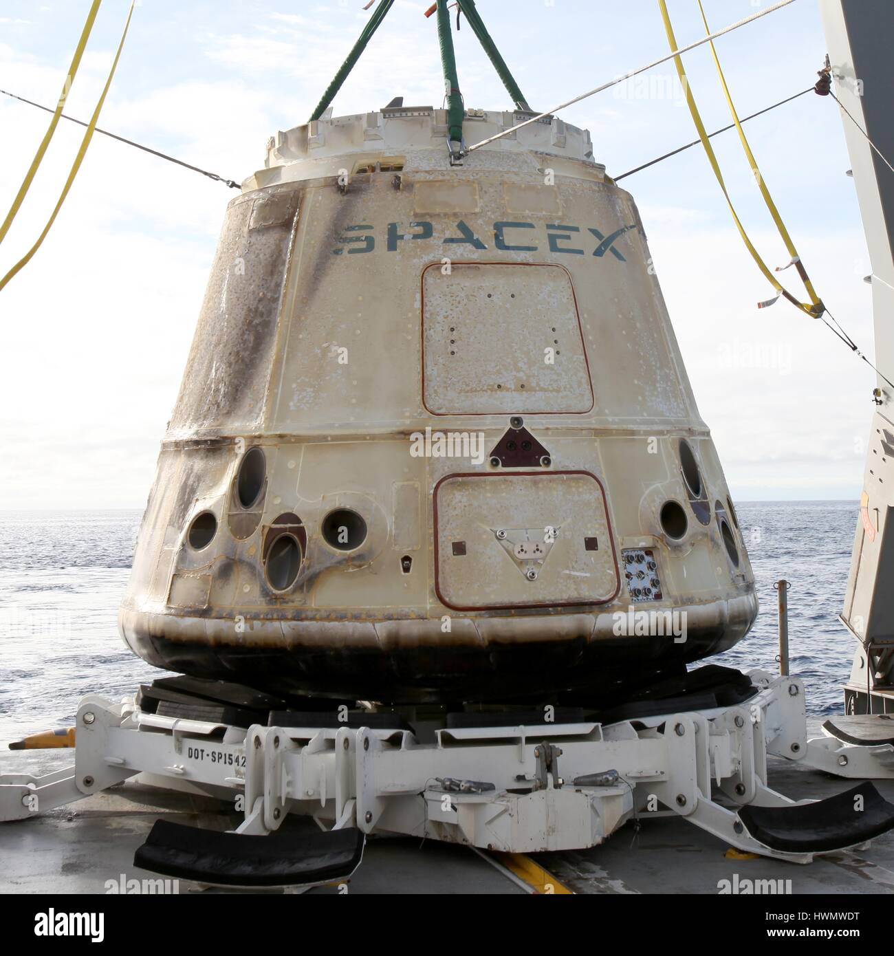 The SpaceX Dragon cargo supply capsule is recovered from the Pacific Ocean onto the deck of the NRC Quest after returning from the International Space Station March 19, 2017 off the coast of Baja, California. The capsule returned carrying and array of biological studies including research into new life-saving drugs from the orbiting laboratory. Stock Photo