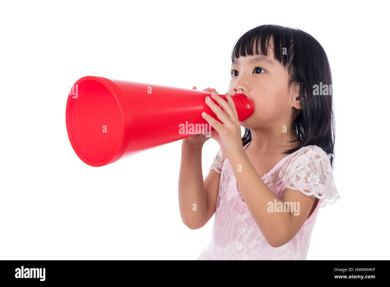 Asian Chinese little girl shouting with retro loudspeaker in isolated white background. Stock Photo