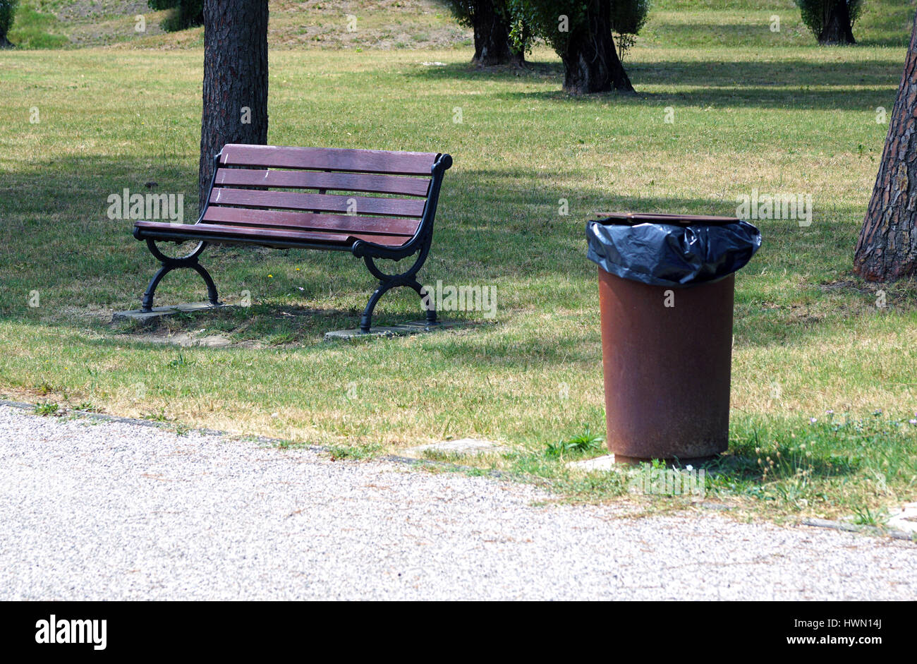 bench and garbage can in the park Stock Photo Alamy
