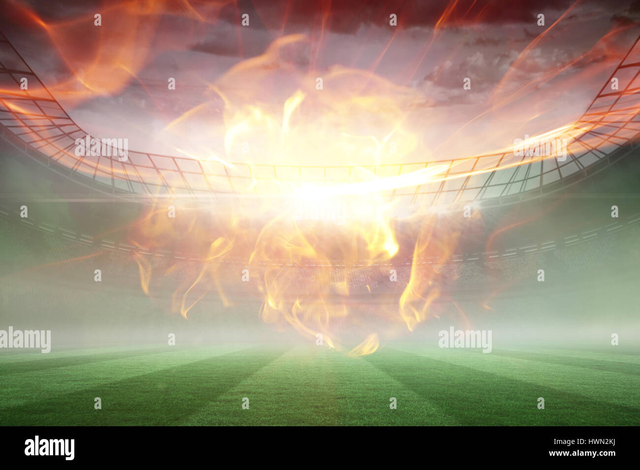 Ball of fire against misty football stadium under floodlights 3d Stock