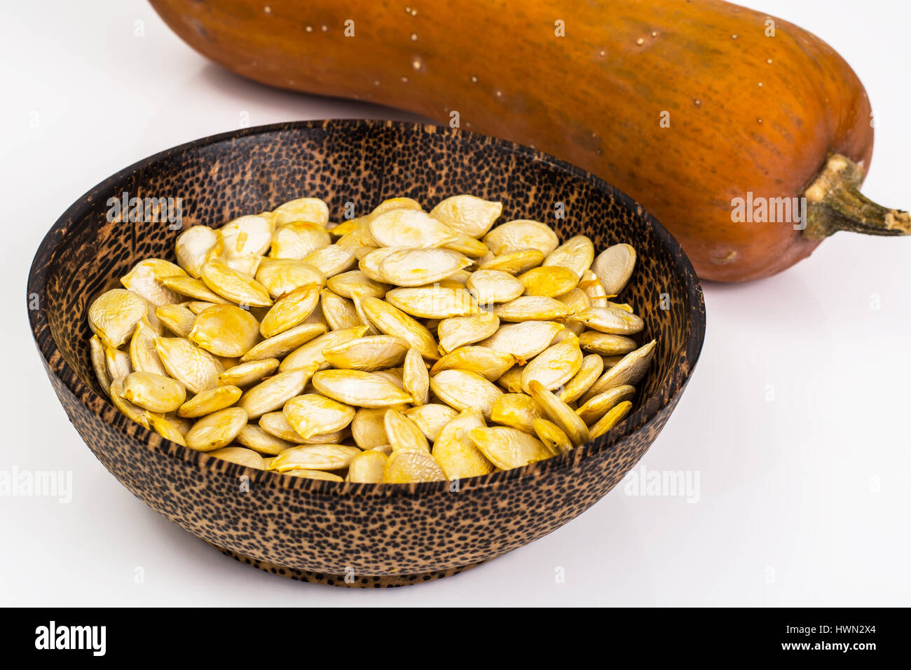 Dry uncooked pumpkin seeds in wooden bowl Stock Photo Alamy