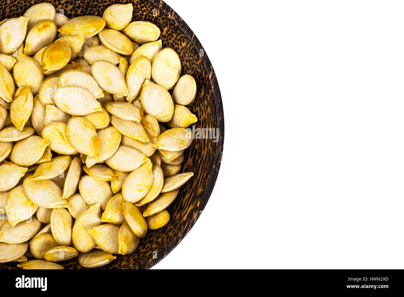 Dry uncooked pumpkin seeds in wooden bowl Stock Photo Alamy