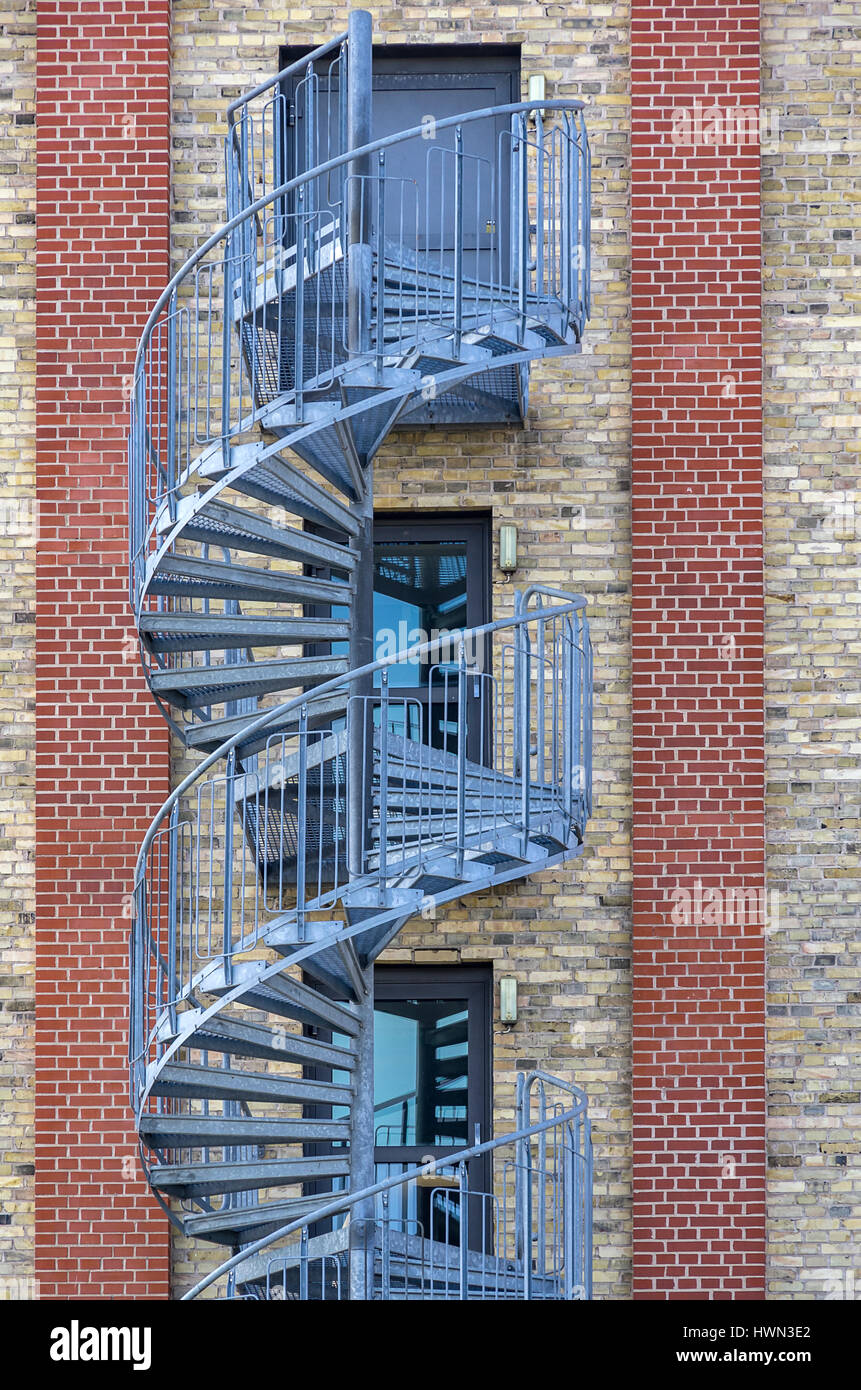 Structures of the city - Spiral staircase at the exterior of an modern building. Stock Photo