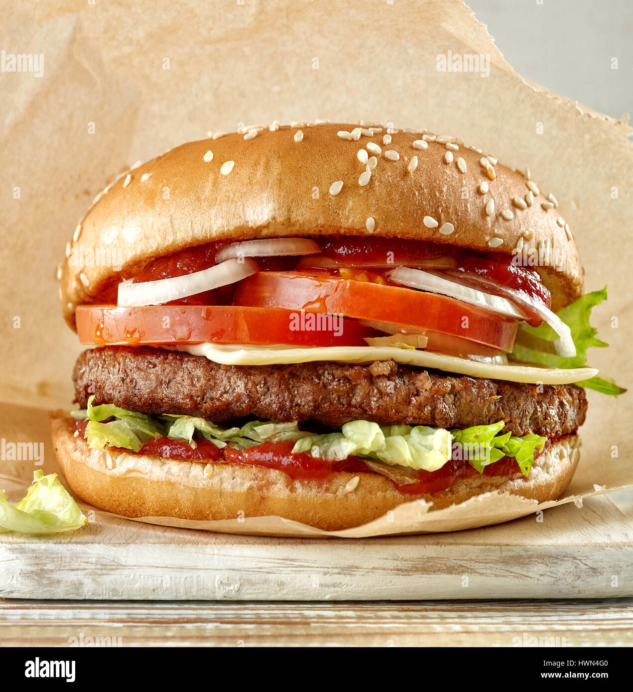 fresh tasty burger on wooden cutting board Stock Photo
