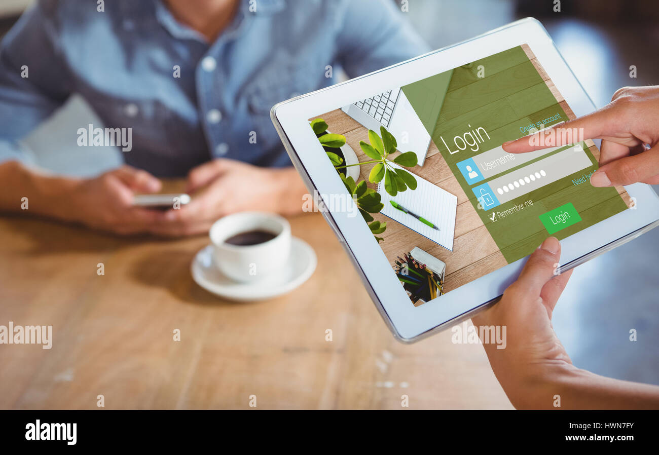 Close-up of login page against person using tablet computer in cafe Stock Photo