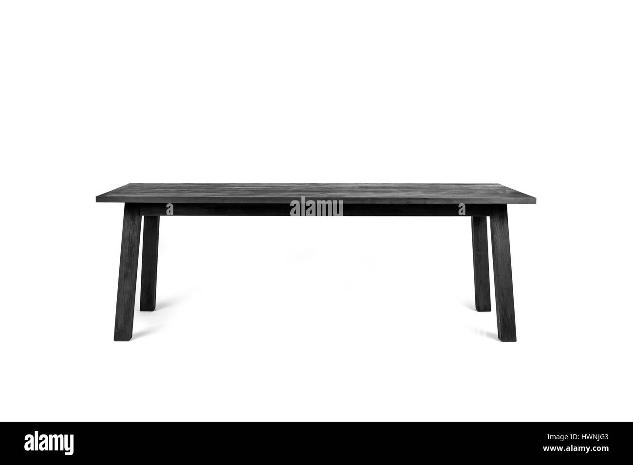 A contemporary table - made out of charred wood according the shou-sugi-ban technique - photographed on a white background. Stock Photo