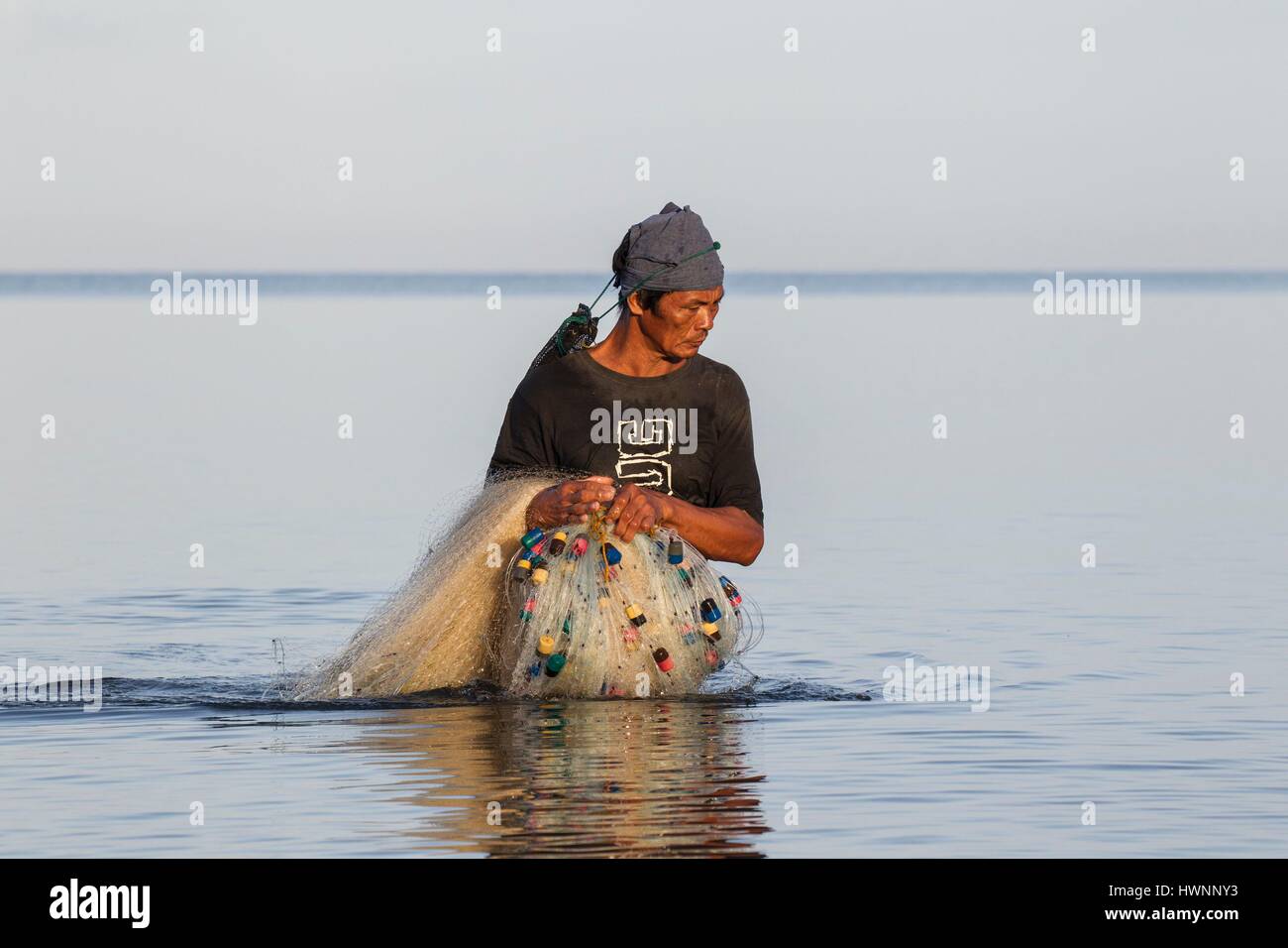 Philippines, Luzon, Sorsogon Province, Donsol, fisherman using fishnet at sunrise Stock Photo