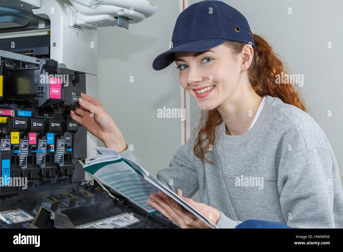 Portrait of woman maintaining photocopier Stock Photo Alamy