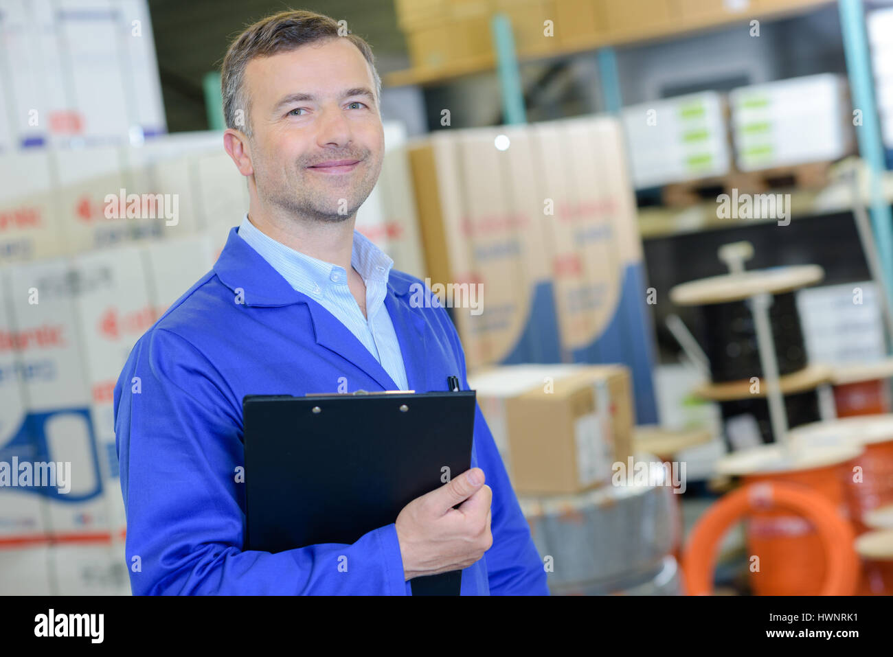 Portrait of man holding clipboard Stock Photo - Alamy