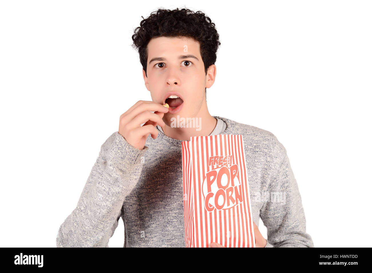 Portrait of young man eating popcorn. Isolated white background Stock Photo Alamy