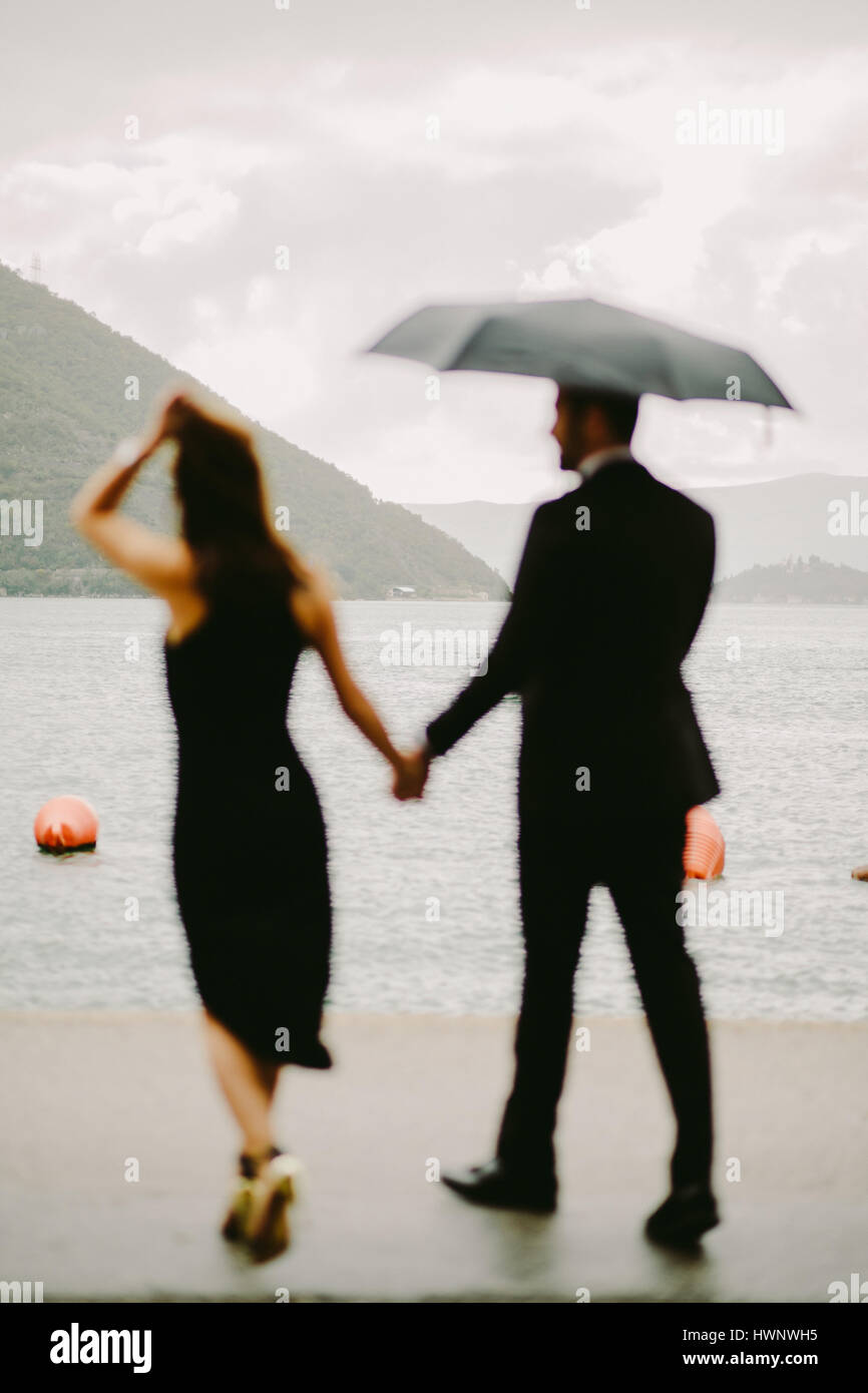 Couple With Umbrella Walking In Rain Stock Photo 136320049 Alamy
