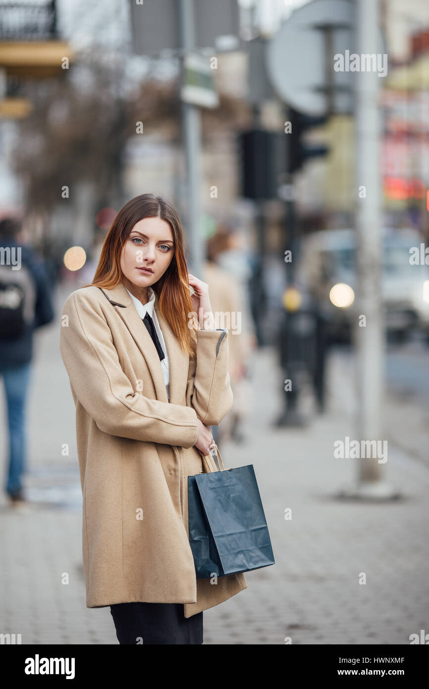 Young woman walking on the street background and smile Stock Photo - Alamy