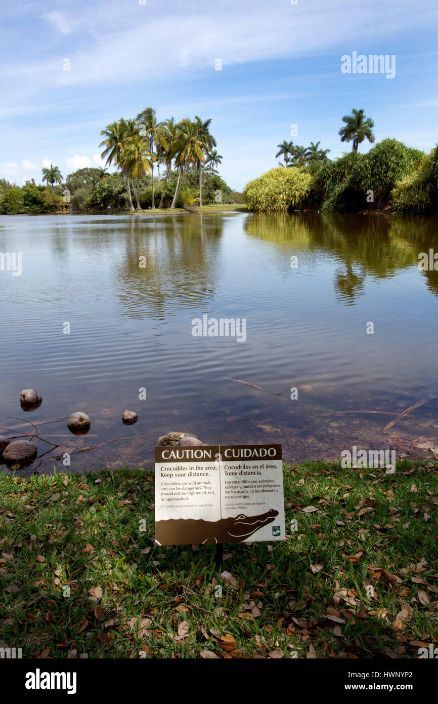 Warning crocodile sign next to pond, Fairchild Tropical Botanic Garden in Coral Gables, Florida Stock Photo