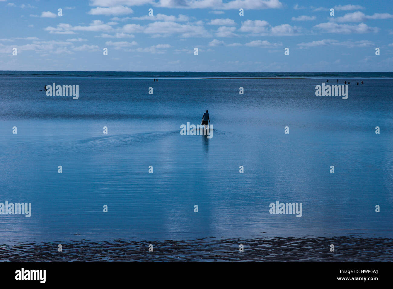 Beach Vacations: Patacho Beach, Alagoas, Brazil, considered one of the most beautiful beaches in Brazil- Fisherman in the background. Stock Photo