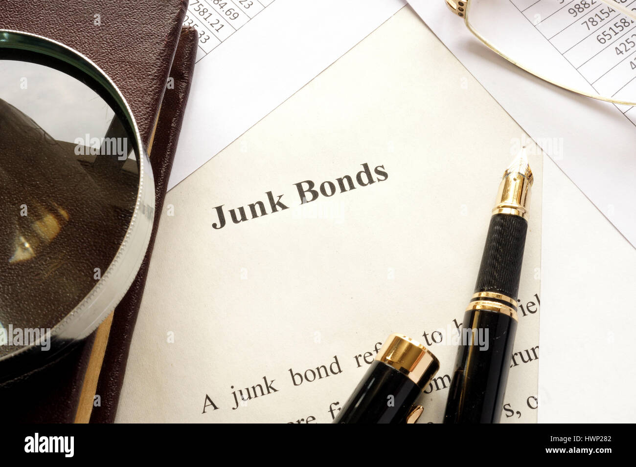 Paper with a title junk bonds and other financial documents. Stock Photo