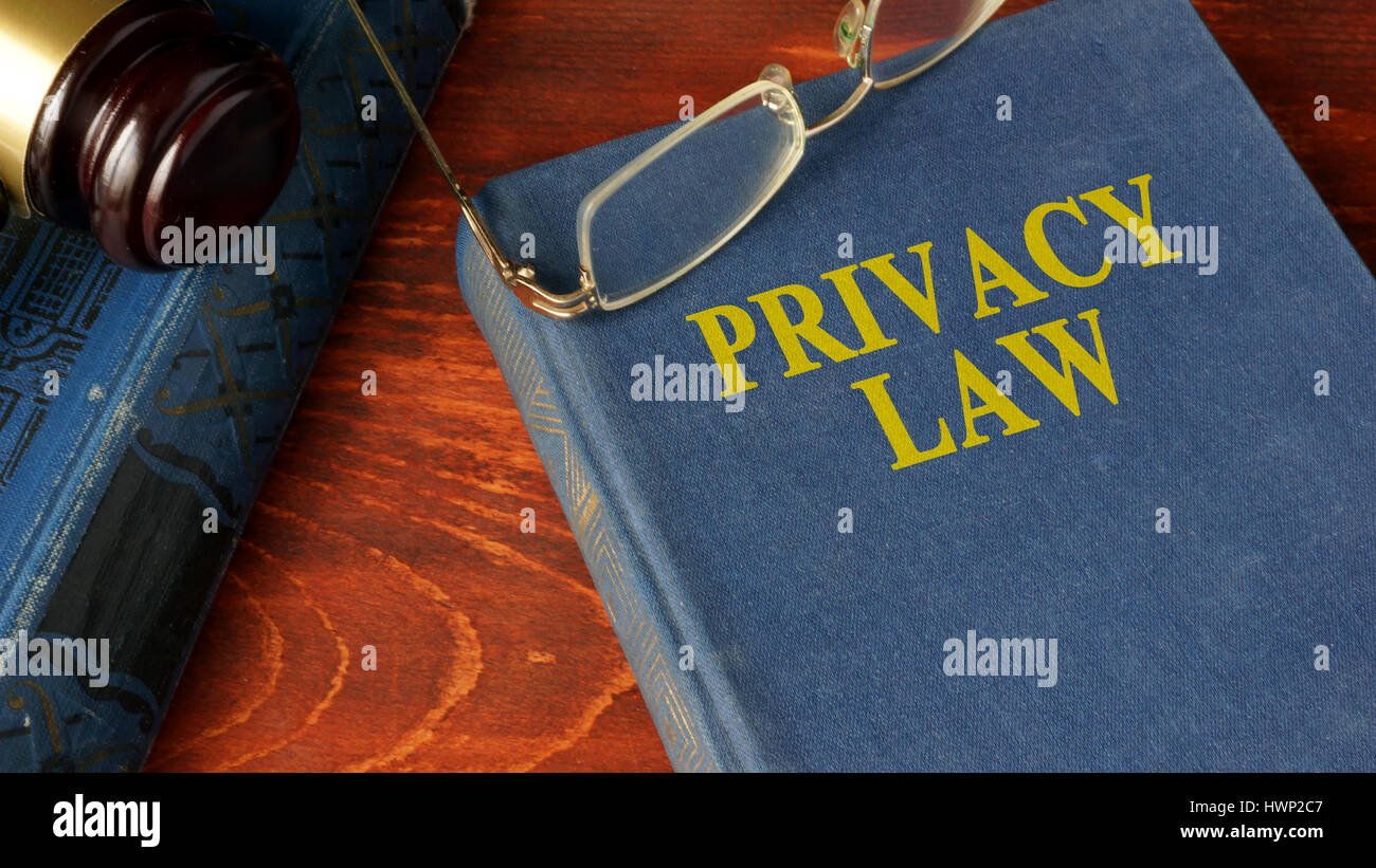 Book with title Privacy Law on a wooden surface. Stock Photo