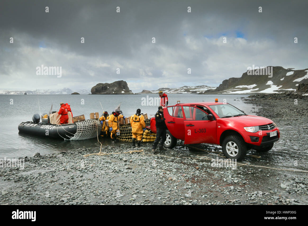 Stores and supplies being loaded onto rigid inflatable boats from Mitsubishi L200 pickup truck, King George Island, Antarctica Stock Photo