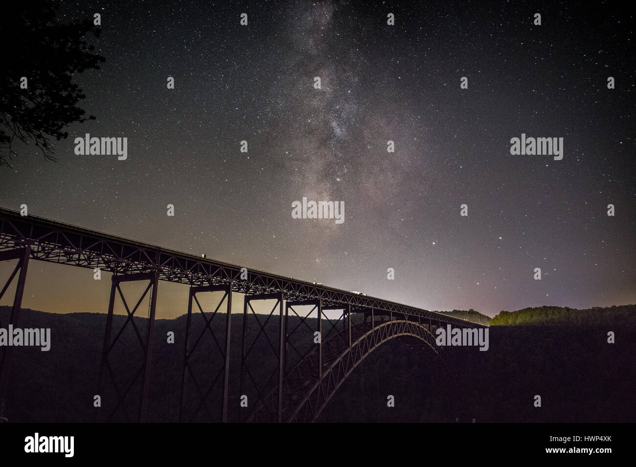 The Milky Way rises above the great steel arch bridge over the New