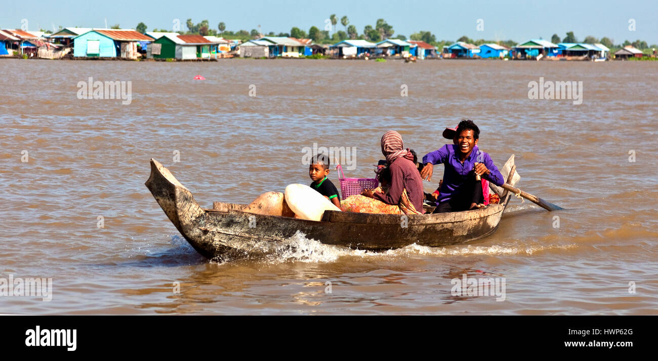 Cambodian family heading to market in their boat at on the Tonlé Sap River at Kampong Chhnang Stock Photo