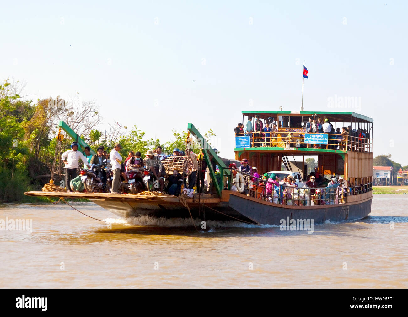 Ferry boat carried people and vehicles across Tonlé Sap River in Cambodia Stock Photo