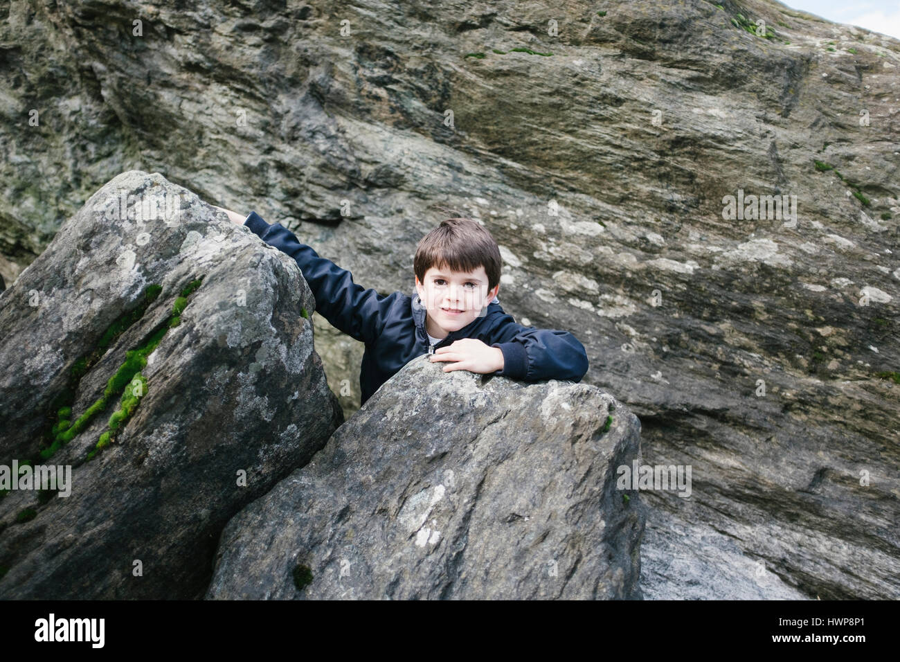 child plays between boulders Stock Photo - Alamy