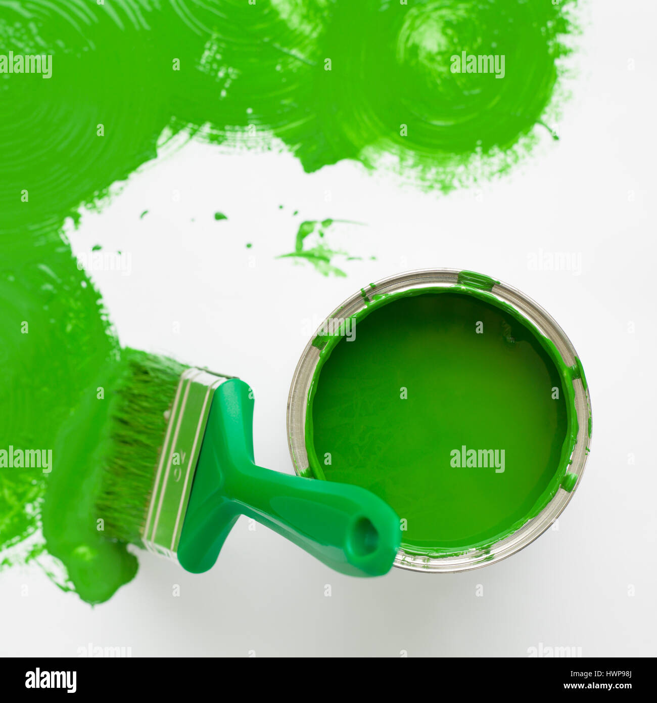 Square image green paint brush with green splash and can. top view ...