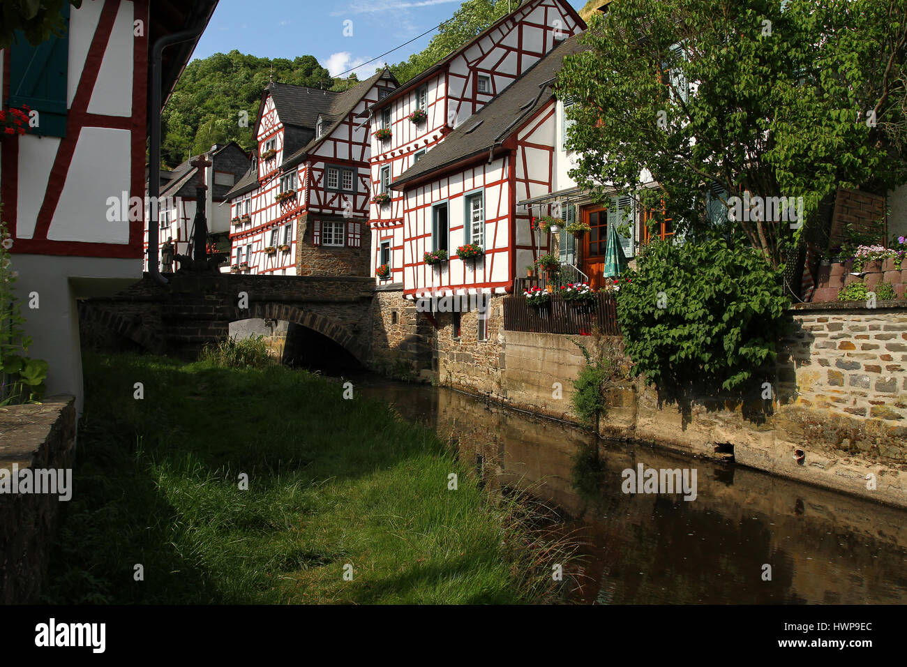 Creek lined with historic houses and wrought iron railing in the medieval village Monreal Germany Stock Photo