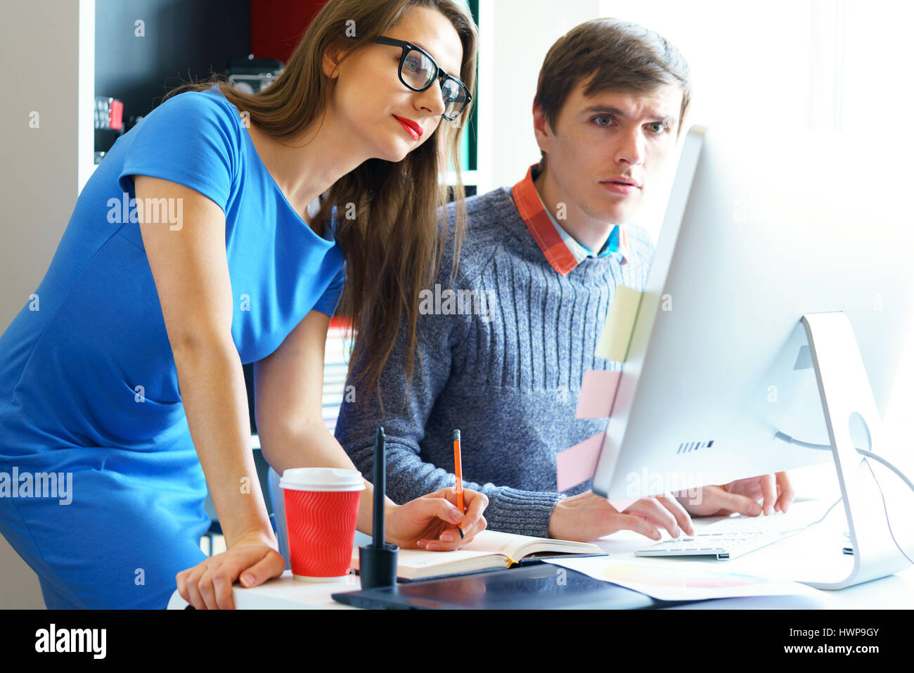Beautiful young woman and man working from home office - modern ...
