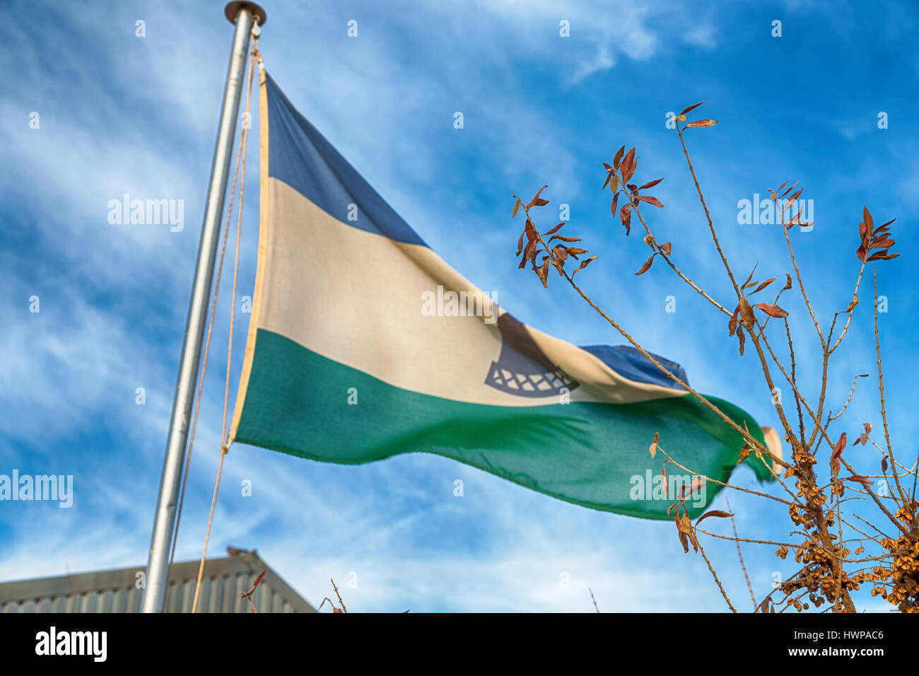 blur in lesotho waving national flag in the cloudy sky Stock Photo - Alamy