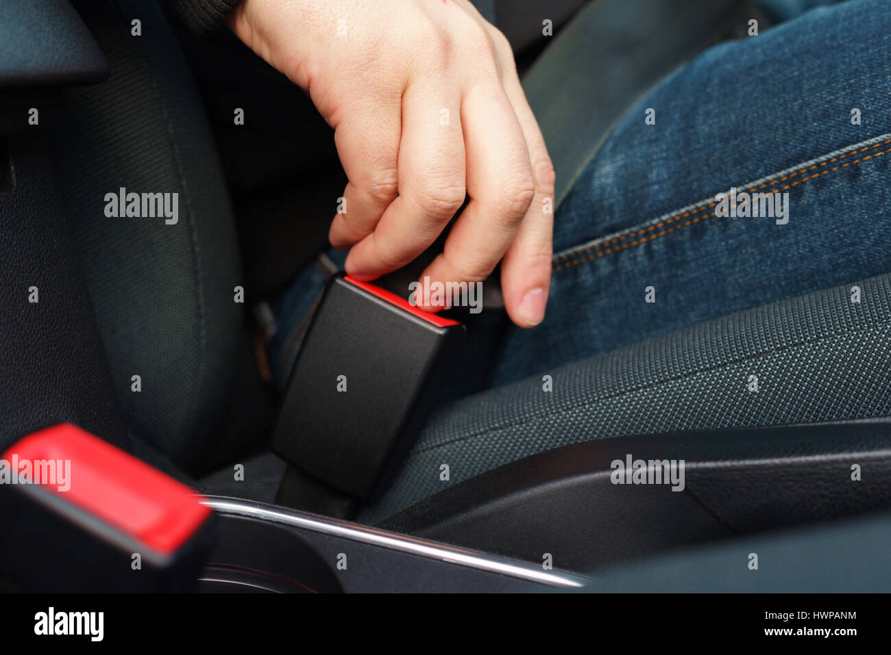 Close up man fastening car safety seat belt while sitting inside of ... Close up man fastening car safety seat belt while sitting inside of ...