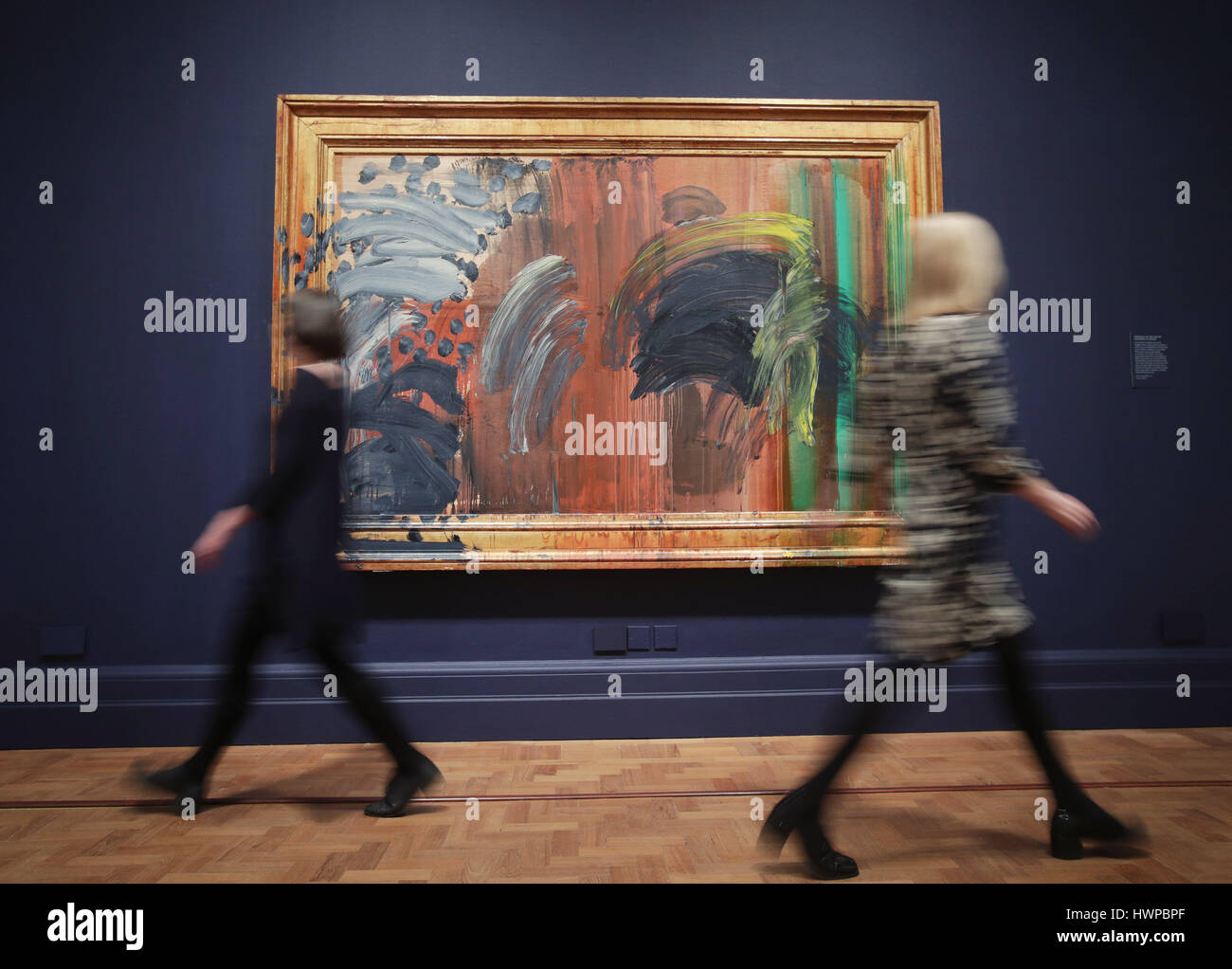 Gallery staff members walking past Portrait of the Artist Listening to Music, 2011-2016, during a press preview of the exhibition Howard Hodgkin: Absent Friends at the National Portrait Gallery in central London. Stock Photo