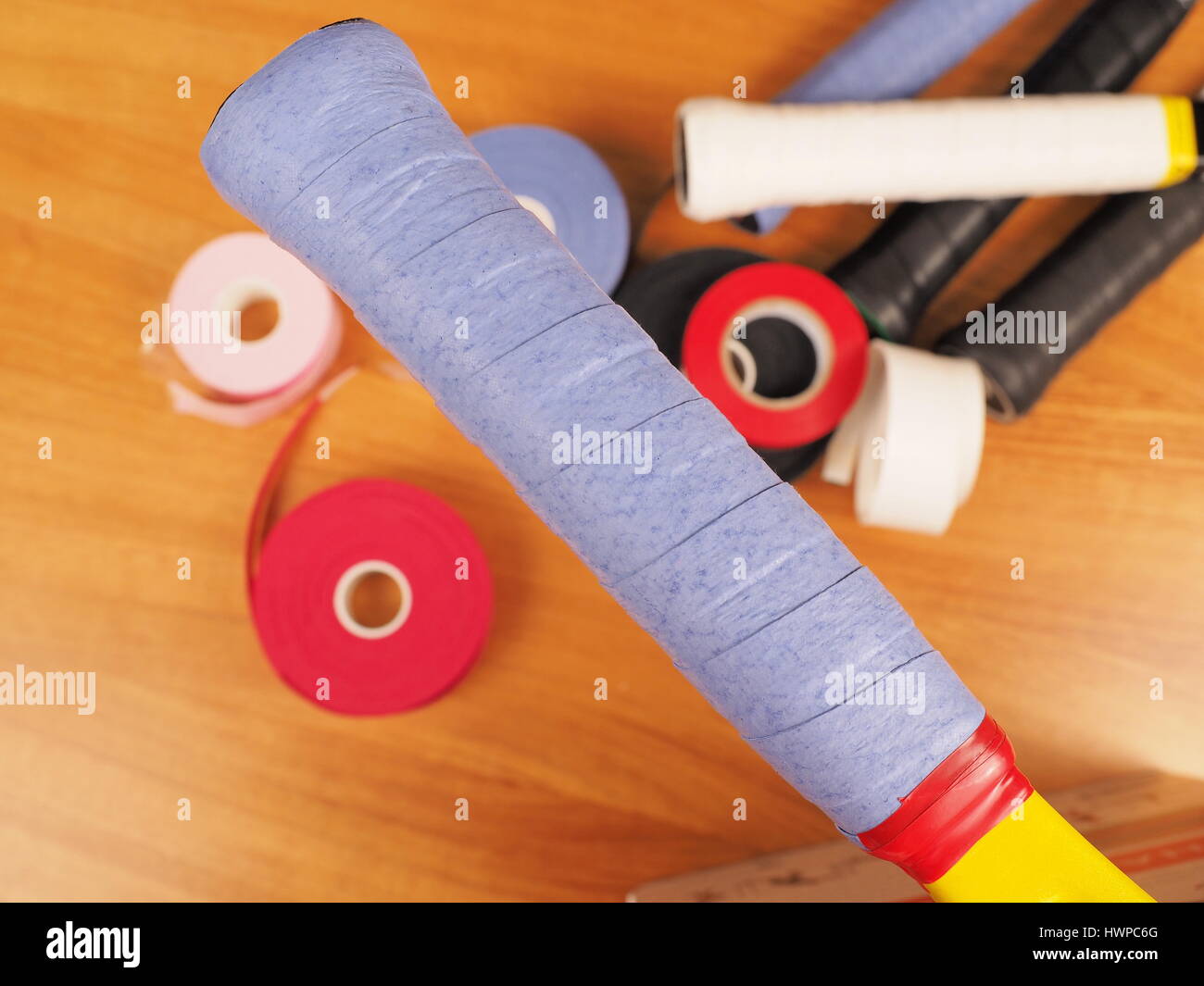 Freshly wrapped blue over grip on a Tennis racket providing a tacky ...