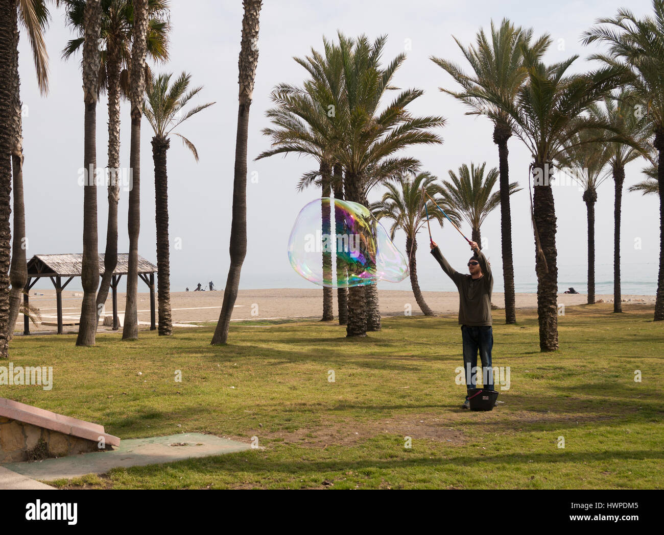 Man making a giant bubble in Torremolinos, Andalusia, Spain Stock Photo