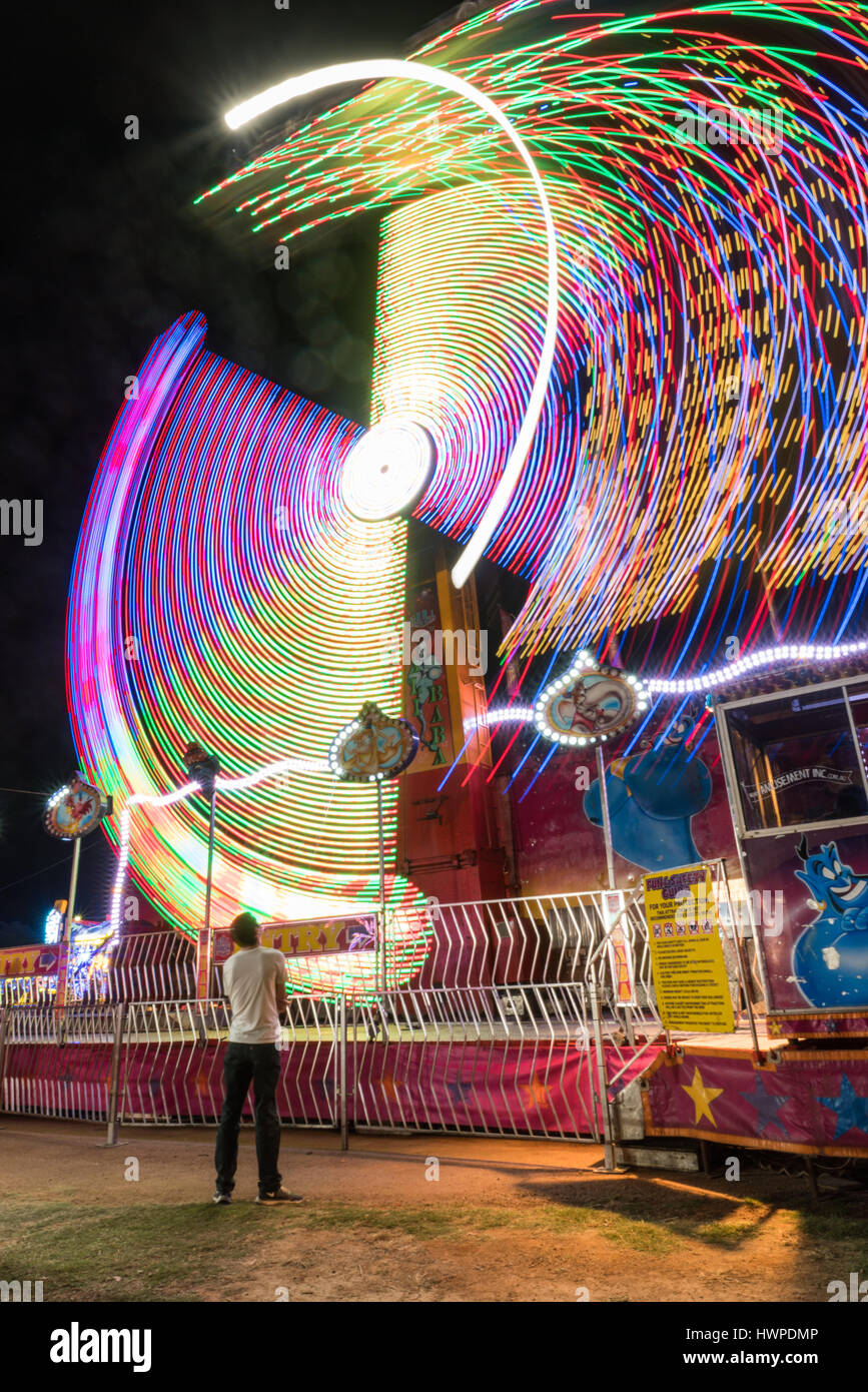 Light trails from long exposure of a carnival ride at the local show, Charters Towers, Australia Stock Photo