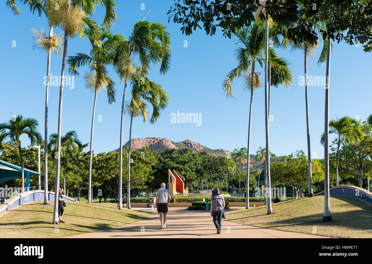 People enjoying time on The Strand, Townsville with iconic Castle Hill in the background. Stock Photo