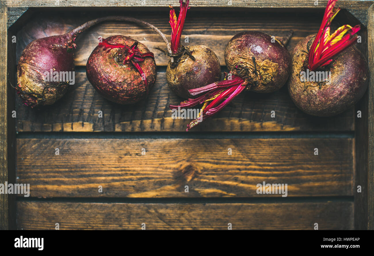 Raw organic purple beetroots in rustic wooden box, copy space Stock Photo