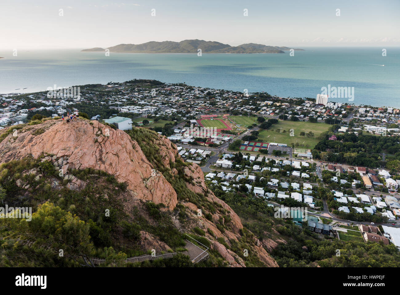 Looking down on Townsville City from Castle Hill viewpoint to The Strand and Magnetic Island beyond Stock Photo