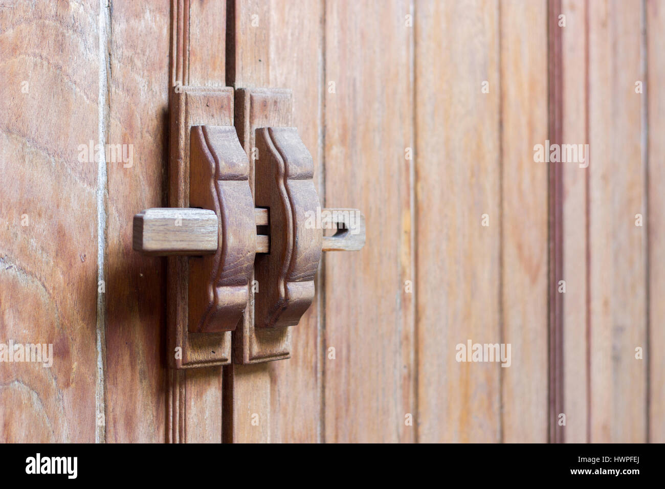 close up wood handle lock on wooden door interior Stock Photo