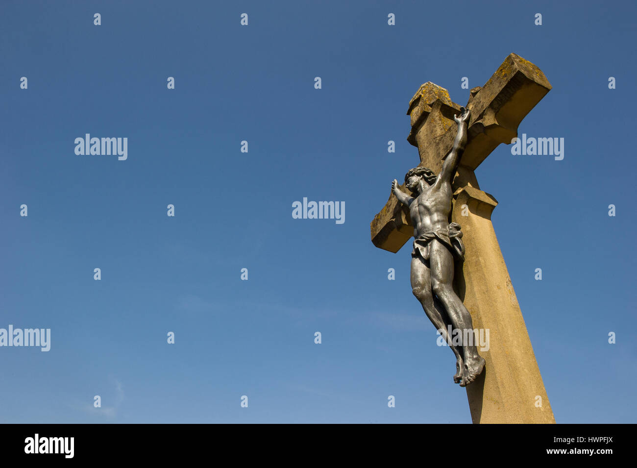 christian stone cross with jesus Stock Photo