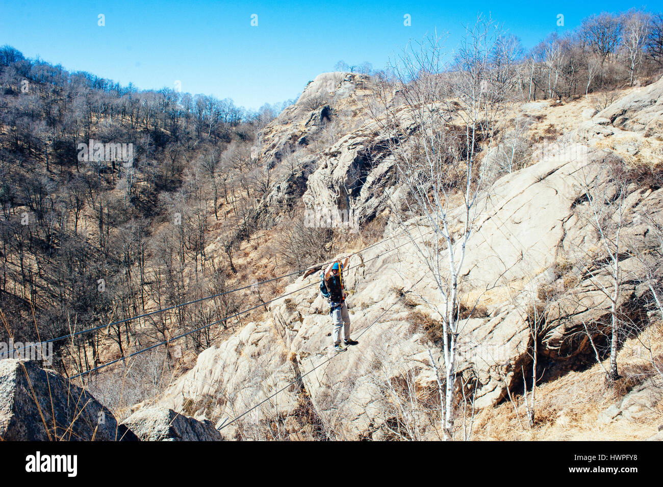 climber on the rope bridge via ferrata picasass Baveno Lake Maggiore