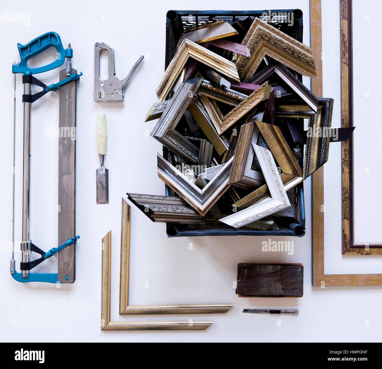 Overhead view of picture frames and corners with work tools on table in workshop Stock Photo