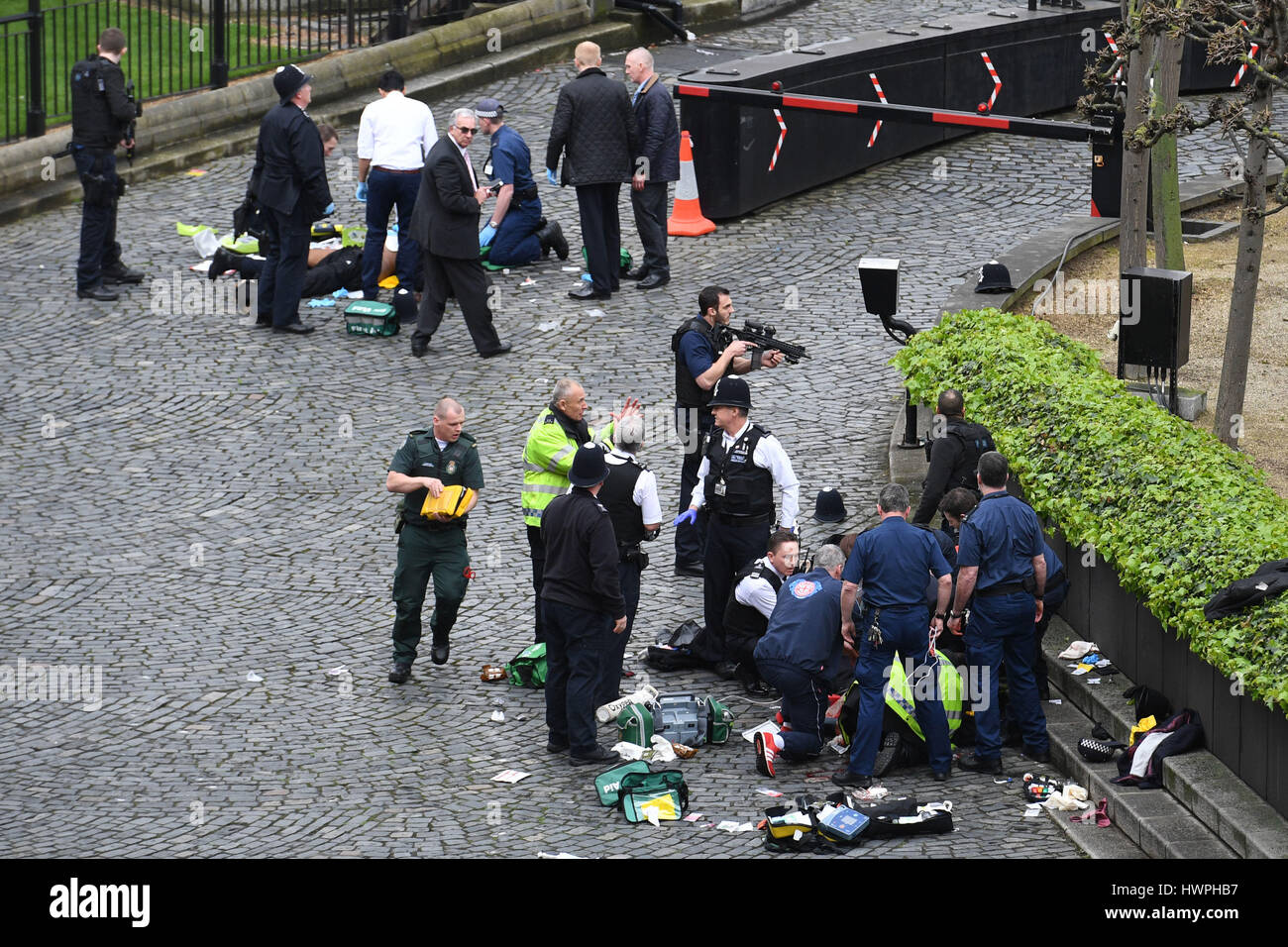 Emergency services attend a man (top) and a police officer (bottom ...