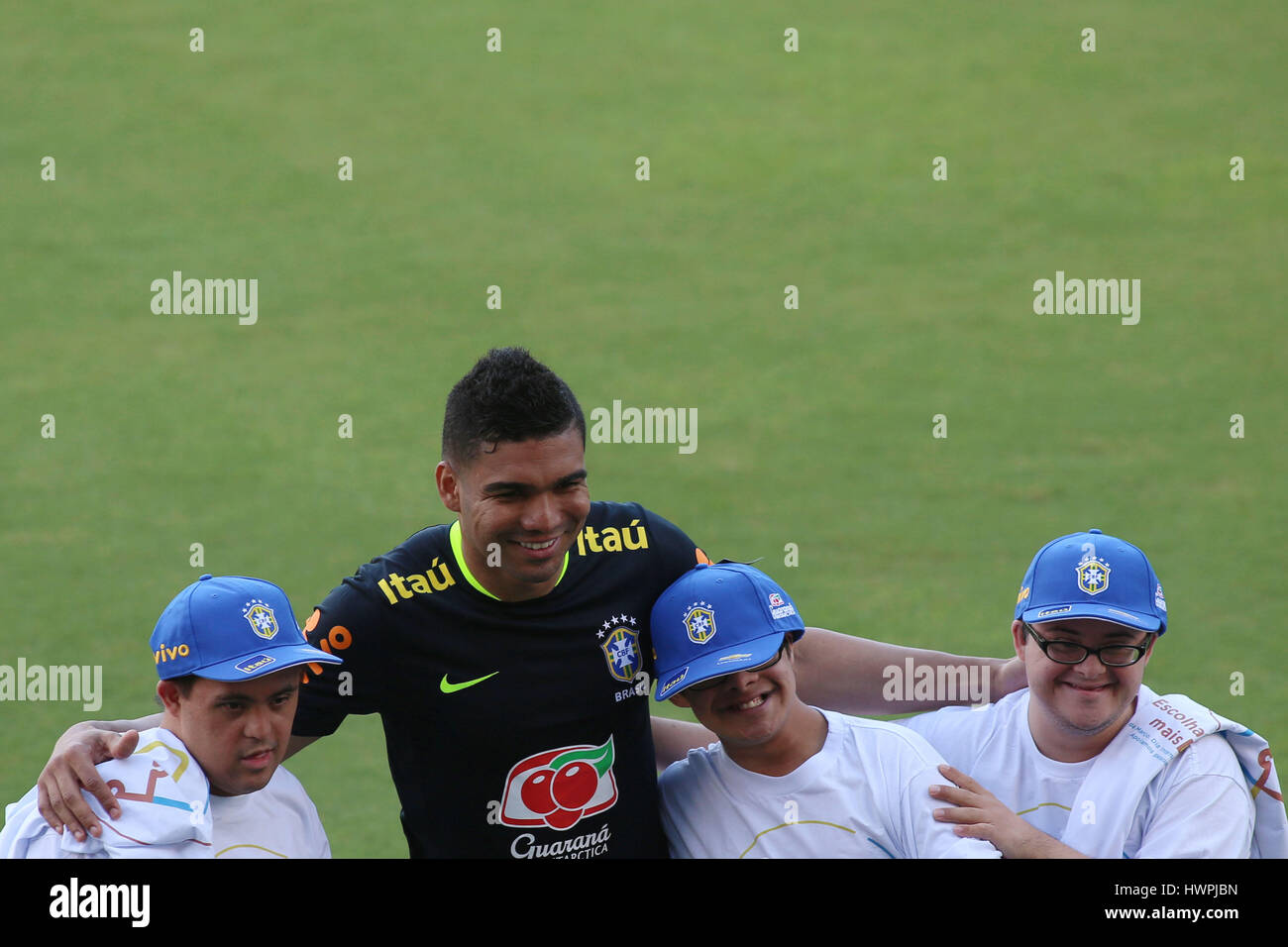Sao Paulo, Brazil. 21st Mar, 2017. Player Casemiro (2nd-L), of the Brazilian national soccer team, poses along kids with Down Syndrome, in the context of the World Down Syndrome Day, during a training session in Sao Paulo, Brazil, on March 21, 2017. Brazil will play against Urugay on March 23 in Montevideo, and against Paraguay on March 28 in Sao Paulo, on Russia 2018 World Cup play-off matches. Credit: Rahel Patrasso/Xinhua/Alamy Live News Stock Photo