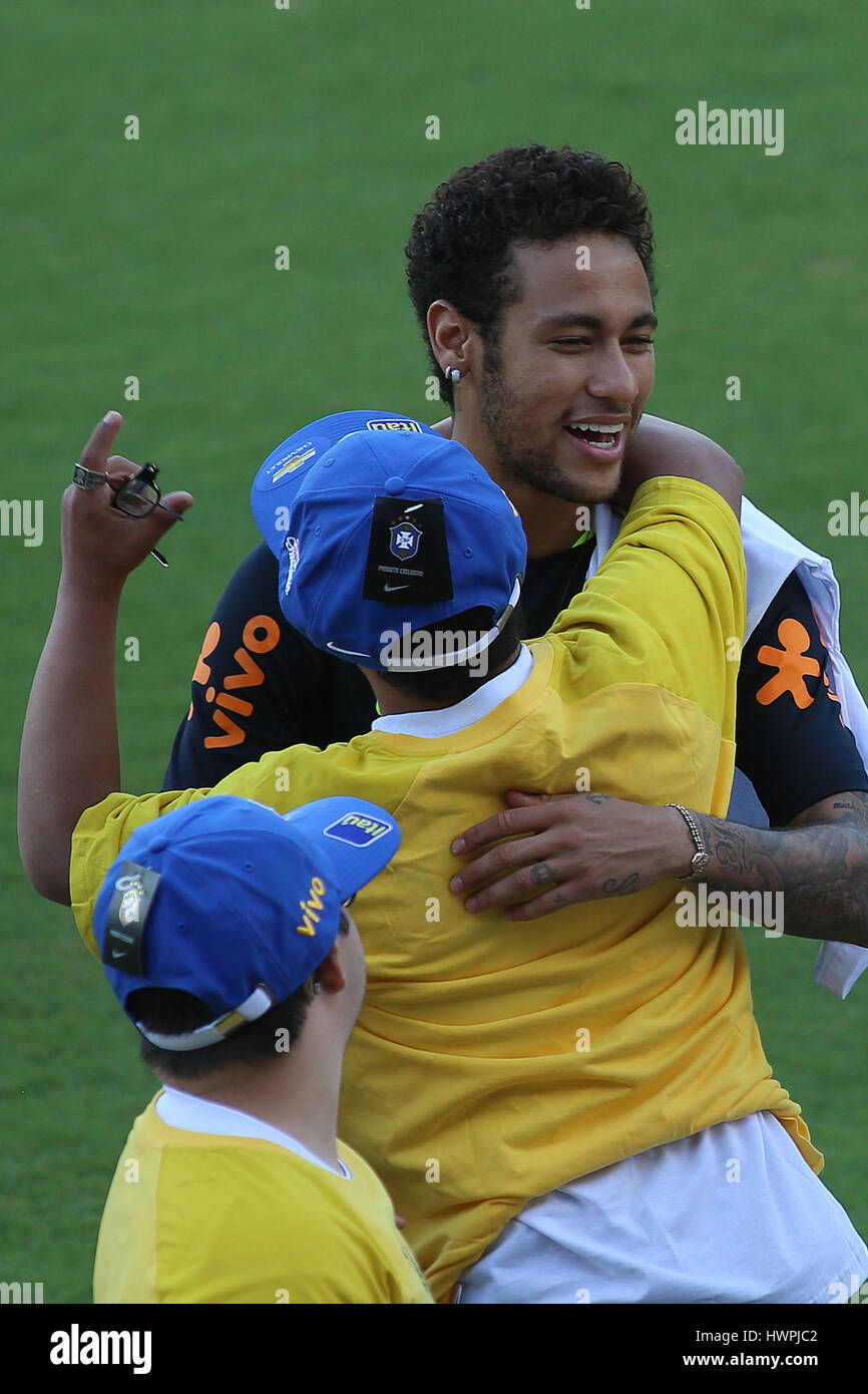 Sao Paulo, Brazil. 21st Mar, 2017. Player Neymar (back), of the Brazilian national soccer team, hugs a boy with Down Syndrome, in the context of the World Down Syndrome Day, during a training session in Sao Paulo, Brazil, on March 21, 2017. Brazil will play against Urugay on March 23 in Montevideo, and against Paraguay on March 28 in Sao Paulo, on Russia 2018 World Cup play-off matches. Credit: Rahel Patrasso/Xinhua/Alamy Live News Stock Photo